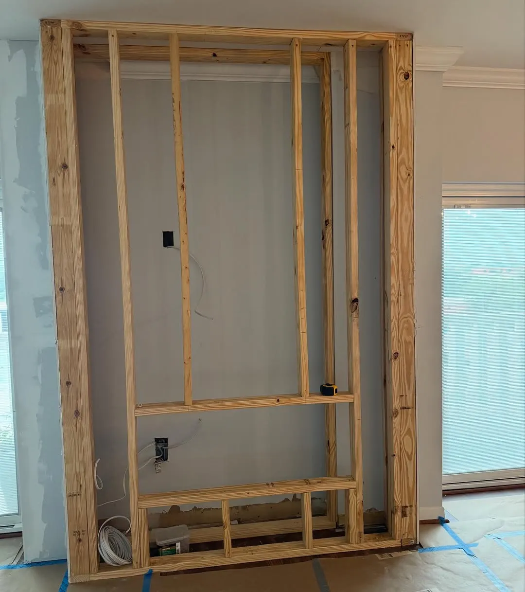 Wood framing for a built-out fireplace and TV wall
